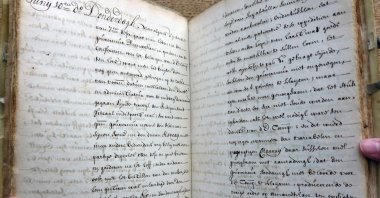 Dutch art detective Arthur Brand holds stolen documents from the 15th to the 19th century, including several UNESCO-listed archives, Amsterdam, Netherlands, July 8, 2025. (AFP Photo)