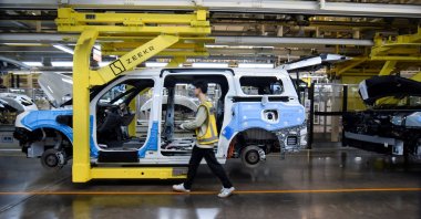 Workers build Zeekr 009 electric minivans at Zeekr's factory, Ningbo, China, April 20, 2025. (Reuters Photo)