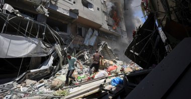 A fire burns as Palestinians inspect the site of Israeli strikes on buildings at Gaza&#039;s Old City market, in Gaza City, Palestine, July 9, 2025. (Reuters Photo)
