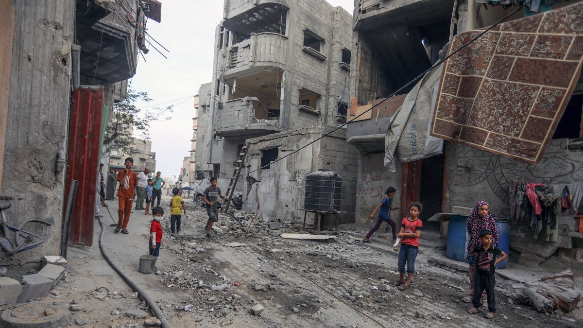 Palestinians clear debris in front of damaged homes after an Israeli army attack on Khan Younis, Gaza, Palestine, July 10, 2025. (AA Photo)
