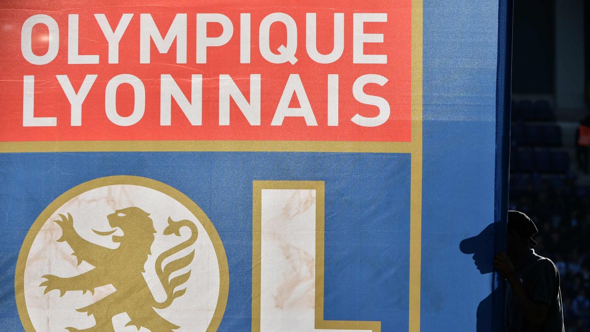 A pedestrian walks past a flag with the logo of Olympique Lyonnais (OL) during the French Ligue 1 football match between Toulouse FC (TFC) and OL at the Municipal Stadium, Toulouse, France, Oct. 29, 2016. (AFP Photo)
