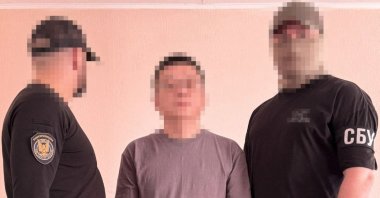 A Chinese citizen (C) detained by the Security Service of Ukraine (SBU) in Kyiv, Ukraine, July 9, 2025. (AFP Photo)