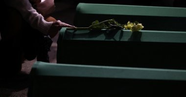 A Bosnian woman touches the coffin of a relative who is one of the seven victims to be buried on July 11 during a mass funeral marking the 30th anniversary of the Srebrenica genocide in Potocari, Bosnia-Herzegovina, July 9, 2025. (Reuters Photo)