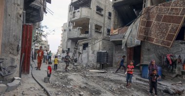 Palestinians clear debris in front of damaged homes after an Israeli army attack on Khan Younis, Gaza, Palestine, July 10, 2025. (AA Photo)