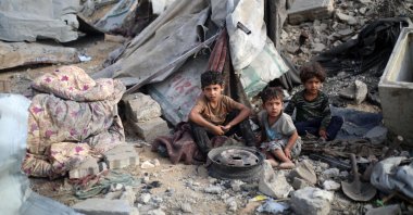 Palestinian children sit amid the destruction in the aftermath of an Israeli strike in the Bureij refugee camp in the central Gaza Strip, Palestine, July 10, 2025. (AFP Photo)
