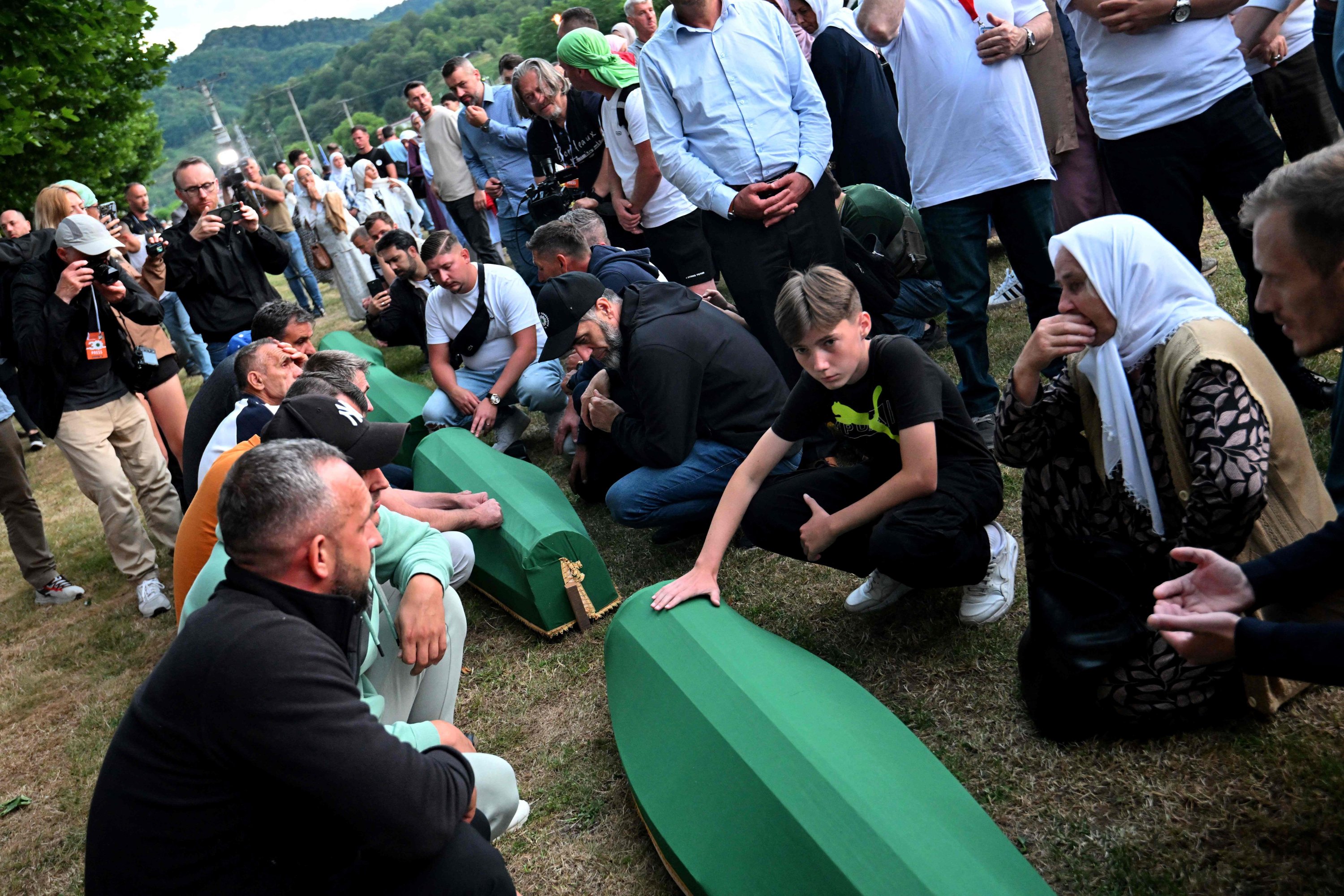 Bosnian Muslims mourn over the caskets with the remains of their relatives ahead of a burial ceremony at the memorial cemetery in the village of Potocari, near the eastern town of Srebrenica, Bosnia-Herzegovina, July 10, 2025. (AFP Photo)