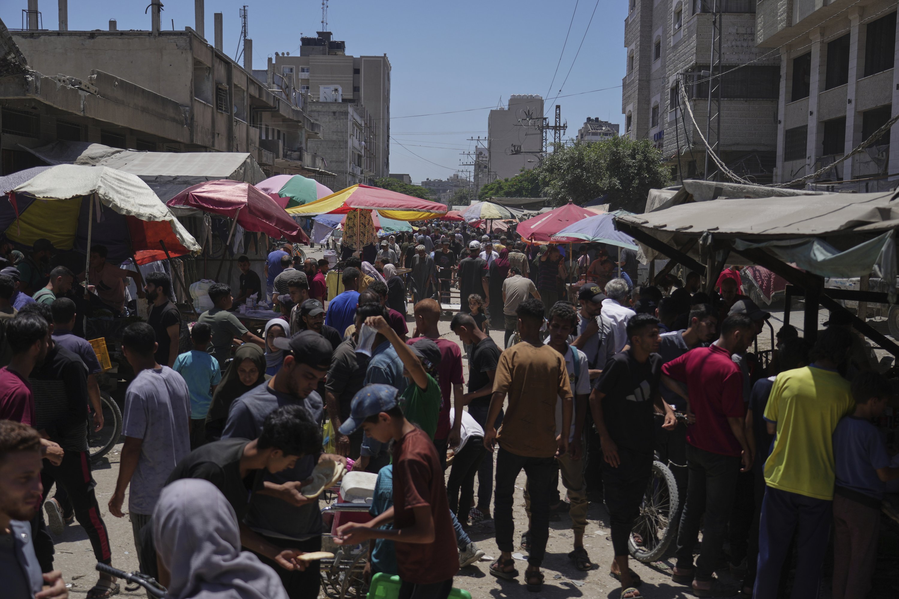 People walk through the al-Sahaba Market, Gaza City, Palestine, July 9, 2025. (AP Photo)