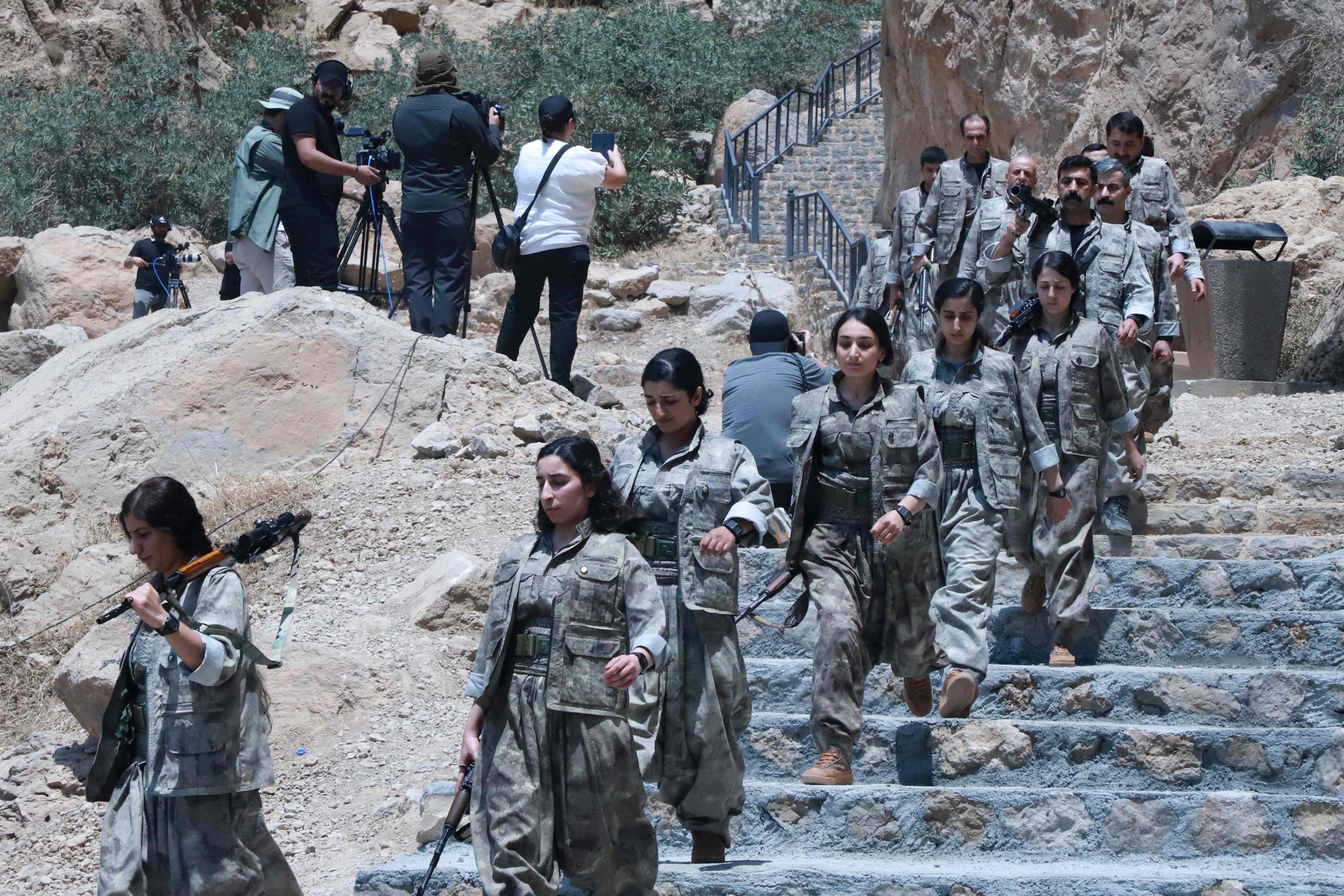 PKK terrorists descend stairs ahead of a disarmament ceremony in the city of Sulaymaniyah, Iraq, July 11, 2025. (AFP Photo)