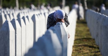 A Bosnian Muslim woman reacts as she stands amid grave stones of victims killed during the Srebrenica genocide, at the memorial cemetery in the village of Potocari, near the eastern town of Srebrenica, Bosnia-Herzegovina, July 11, 2025. (Reuters Photo)