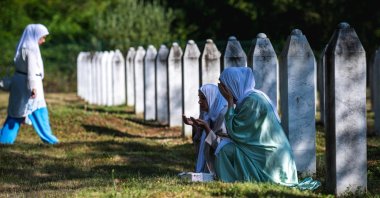 Women pray among the gravestones at the memorial cemetery in the village of Potocari on the 30th anniversary of the Srebrenica massacre, Srebrenica, Bosnia-Herzegovina, July 11, 2025. (AFP Photo)