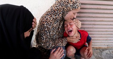Palestinian mother Samah al-Nouri, whose daughter Sama was killed by an Israeli strike, near a medical center in Deir al-Balah, comforts her son, as casualties from the strike are brought into Al-Aqsa Martyrs Hospital, Deir al-Balah, Gaza Strip, Palestine, July 10, 2025. (Reuters Photo)