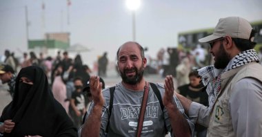 Khalil (C), an Afghan refugee, who lived in Iran for 30 years, reacts after arriving at a temporary camp at Islam Qala border, Herat province, Afghanistan, July 10, 2025. (EPA Photo)