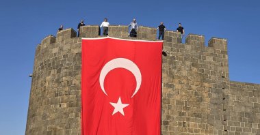 A giant Turkish flag hangs on the ancient city walls of Diyarbakır, where the PKK was founded years ago, southeastern Türkiye, July 12, 2025. (AA Photo)