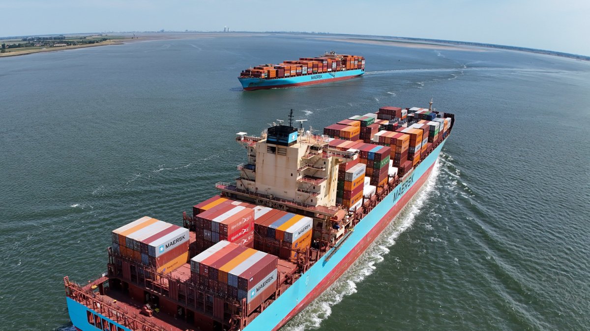 A container ship arriving from Norfolk Harbour, U.S., en route to Antwerp Harbor, and a ship (L) sailing after departing from Antwerp Harbor, Hansweert, Netherlands, June 20, 2025. (EPA Photo)