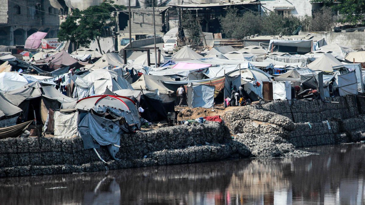 Encampments sheltering war-displaced Palestinians are seen near the Sheikh Radwan wastewater collection pond, Gaza City, Palestine, July 14, 2025. (AFP Photo)
