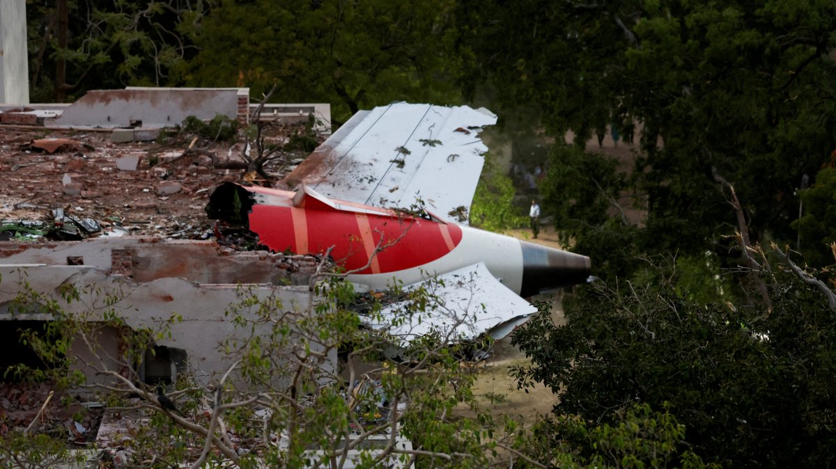 The tail of an Air India Boeing 787 Dreamliner plane that crashed is seen stuck on a building after the incident in Ahmedabad, India, June 12, 2025. (Rueters Photo)