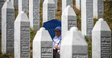 A woman sits near gravestones at the memorial cemetery in the village of Potocari on the 30th anniversary of the Srebrenica massacre, near the eastern Bosnian town of Srebrenica, Bosnia-Herzegovina, July 11, 2025. (AFP Photo)