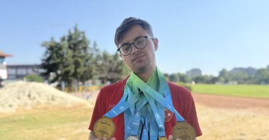 Türkiye’s Down syndrome athletics star Emirhan Akçakoca poses for a photo with his medals he won at the 2025 Down Syndrome European Championships, Tekirdağ, Türkiye, July 9, 2025. (AA Photo)