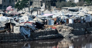 Encampments sheltering war-displaced Palestinians are seen near the Sheikh Radwan wastewater collection pond, Gaza City, Palestine, July 14, 2025. (AFP Photo)