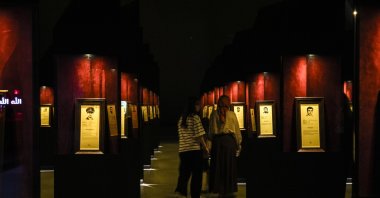 Visitors attentively view the biographies and photos of 253 martyrs at the 15 July Democracy Museum, Istanbul, Türkiye, July 10, 2025. (AA Photo)