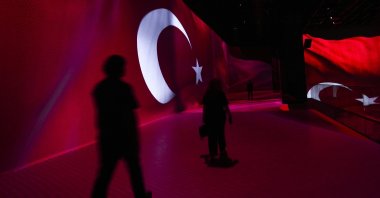 People walk by an installation featuring the Turkish flag at the 15 July Democracy Museum, Ankara, Türkiye, July 13, 2025. (AA Photo)