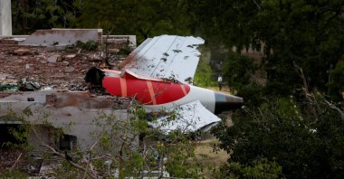 The tail of an Air India Boeing 787 Dreamliner plane that crashed is seen stuck on a building after the incident in Ahmedabad, India, June 12, 2025. (Rueters Photo)
