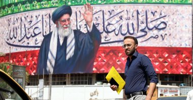 A person walks past a billboard featuring a picture of Iranian Supreme Leader Ayatollah Ali Khamenei at Valiasr Square in Tehran, Iran, July 14, 2025. (EPA Photo)