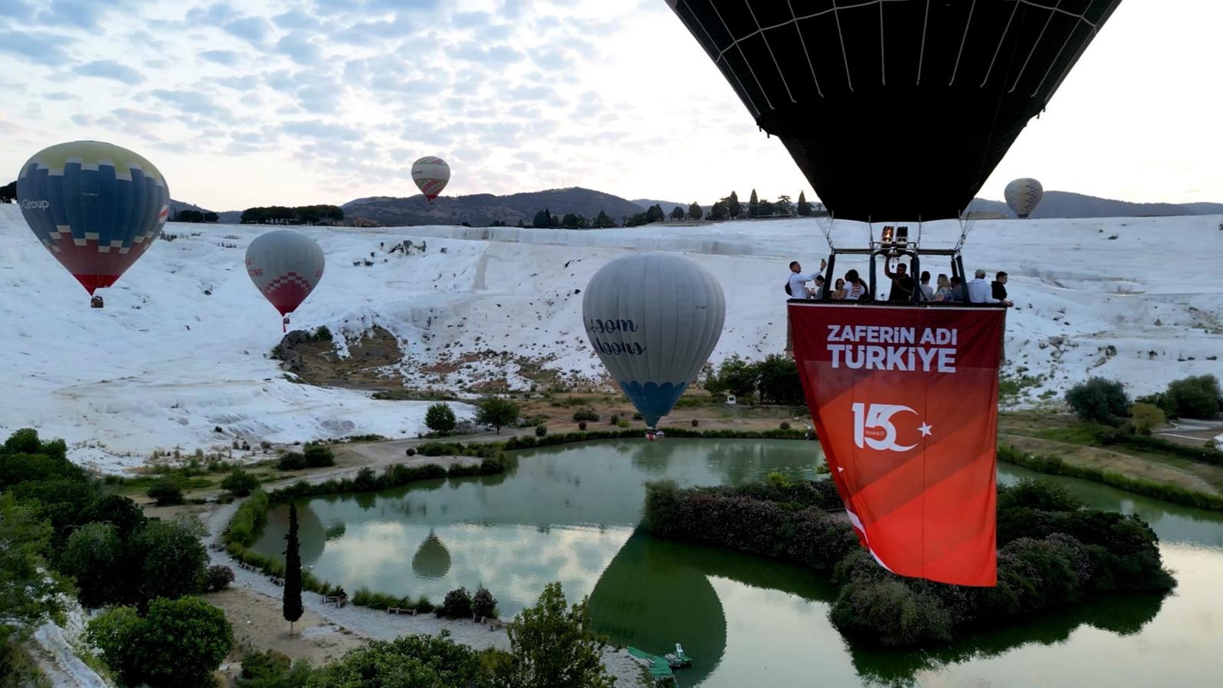 Hot air balloons decorated with Turkish flags and banners soar over Pamukkale to mark July 15 Democracy and National Unity Day, Denizli, Türkiye, July 15, 2025. (AA Photo)