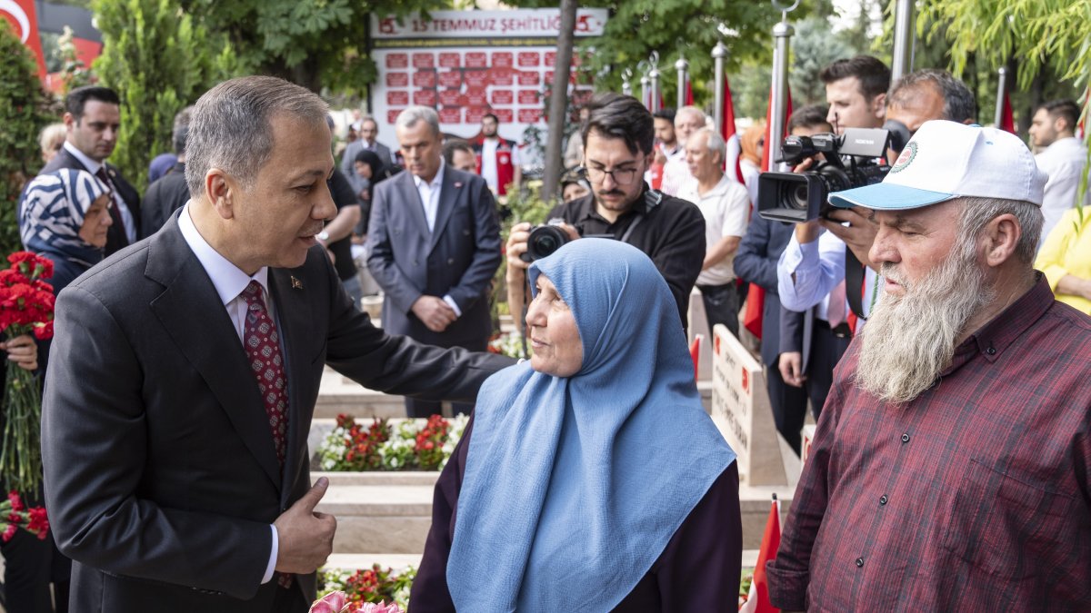 Interior Minister Ali Yerlikaya speaks with families during a visit to a cemetery of coup attempt victims, Ankara, Türkiye, July 15, 2025. (AA Photo)