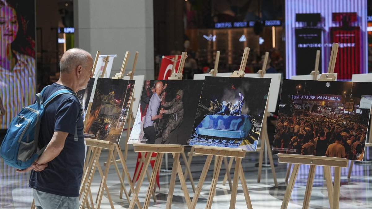 A man looks at photos at an exhibition as part of the July 15 Democracy and National Unity Day events in Izmir, western Türkiye, July 15, 2025. (AA Photo)