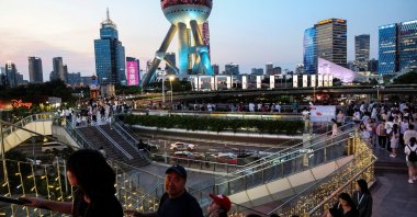 People walk on a pedestrian bridge at Lujiazui financial district, Shanghai, China, July 14, 2025. (Reuters Photo)