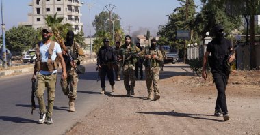 Members of Syrian security forces walk together after Syrian troops entered the predominantly Druze city of Suwayda, Syria, July 15, 2025. (Reuters Photo)