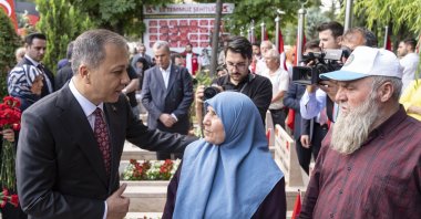 Interior Minister Ali Yerlikaya speaks with families during a visit to a cemetery of coup attempt victims, Ankara, Türkiye, July 15, 2025. (AA Photo)