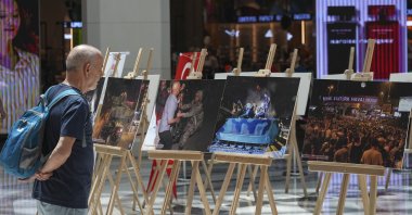 A man looks at photos at an exhibition as part of the July 15 Democracy and National Unity Day events in Izmir, western Türkiye, July 15, 2025. (AA Photo)