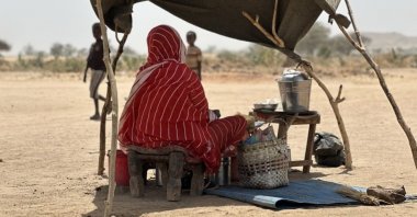 A war-displaced Sudanese woman sits at a camp in North Kordofan, Sudan, July 15, 2025. (IHA)