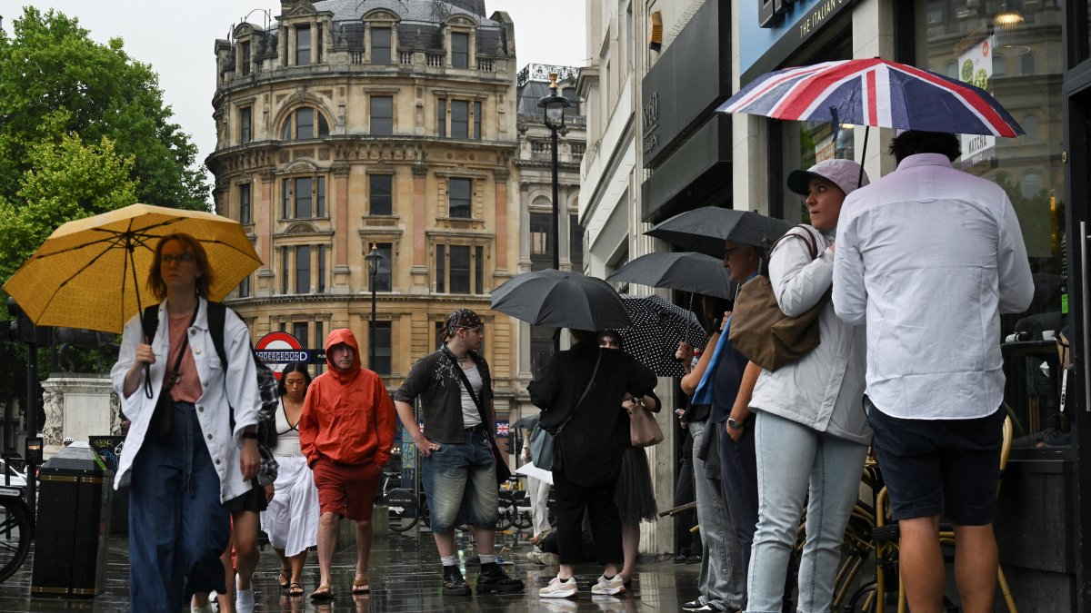 People walk at Trafalgar Square while carrying umbrellas during rainy weather after a heat wave in previous days, London, U.K., July 2, 2025. (Reuters Photo)
