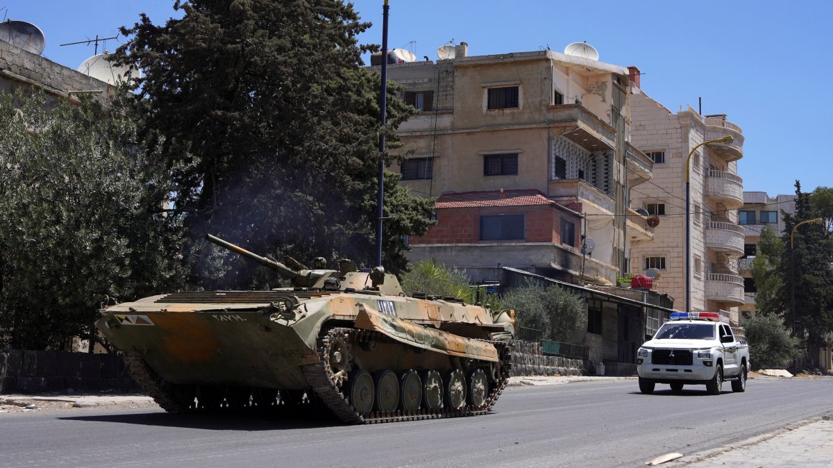 A military vehicle drives along a street, after clashes between Syrian government troops and local Druze fighters resumed in the southern Druze city of Suwayda early on Wednesday, collapsing a ceasefire announced just hours earlier that aimed to put an end to days of deadly sectarian bloodshed, in Suwayda, Syria July 16, 2025. (Reuters Photo)
