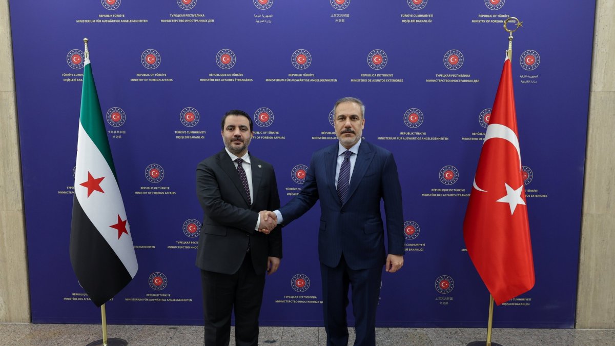 Foreign Minister Hakan Fidan and Syrian Foreign Minister Asaad Hassan al-Shaibani posing for a photo during their meeting in Ankara, Jan. 15, 2025. (EPA via Foreign Ministry)