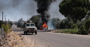 A vehicle in flames amid ongoing clashes in the southern city of Suwayda, southern Syria, July 16, 2025. (EPA Photo)