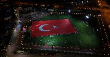 An aerial view shows the world’s largest Turkish flag unfurled during July 15 commemorations at the Talas parachute landing area, Kayseri, Türkiye, July 15, 2025. (IHA Photo)