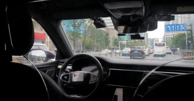 A driverless car by Apollo Go, Baidu&#039;s robotaxi service, drives on a road in Wuhan, Hubei province, China, July 19, 2024. (Reuters Photo)