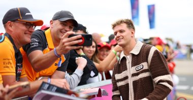 Alpine reserve driver Mick Schumacher takes a photograph with fans ahead of practice during the British Grand Prix at the Silverstone Circuit, Silverstone, U.K., July 5, 2025. (Reuters Photo)