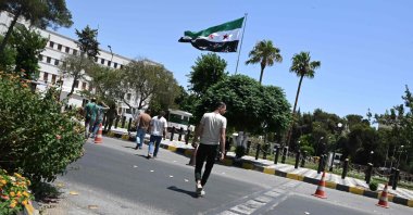 Syrians cross a road next to the Defense Ministry near Ummayad Square after Israel said it hit the nearby military headquarters with a drone, Damascus, Syria, July 16, 2025. (AFP Photo)