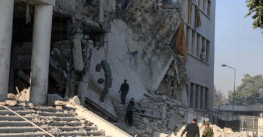 Members of the Syrian security forces assess the destruction inside the heavily damaged Syrian army and defense ministry headquarters complex in Damascus, following Israeli strikes, July 16, 2025. (AFP Photo)