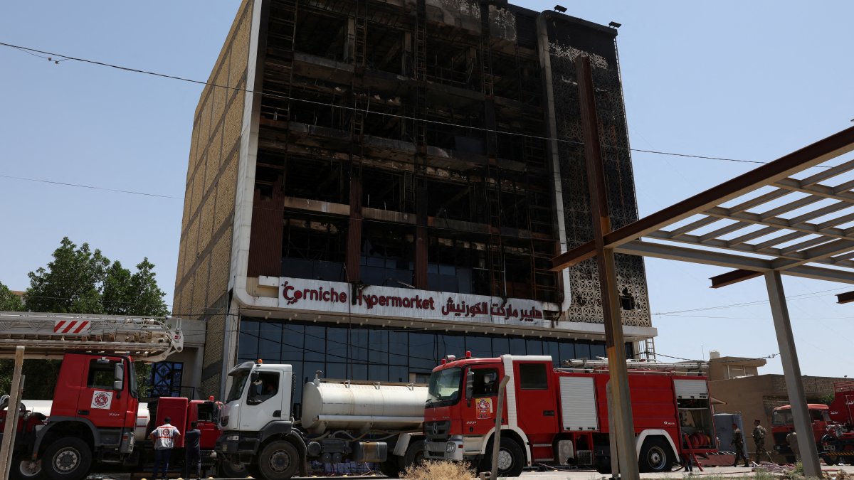 Fire trucks stand next to the wreckage of a shopping mall, after a massive overnight fire killed dozens of people, in Kut, Wasit province, Iraq, July 17, 2025. (Reuters Photo)