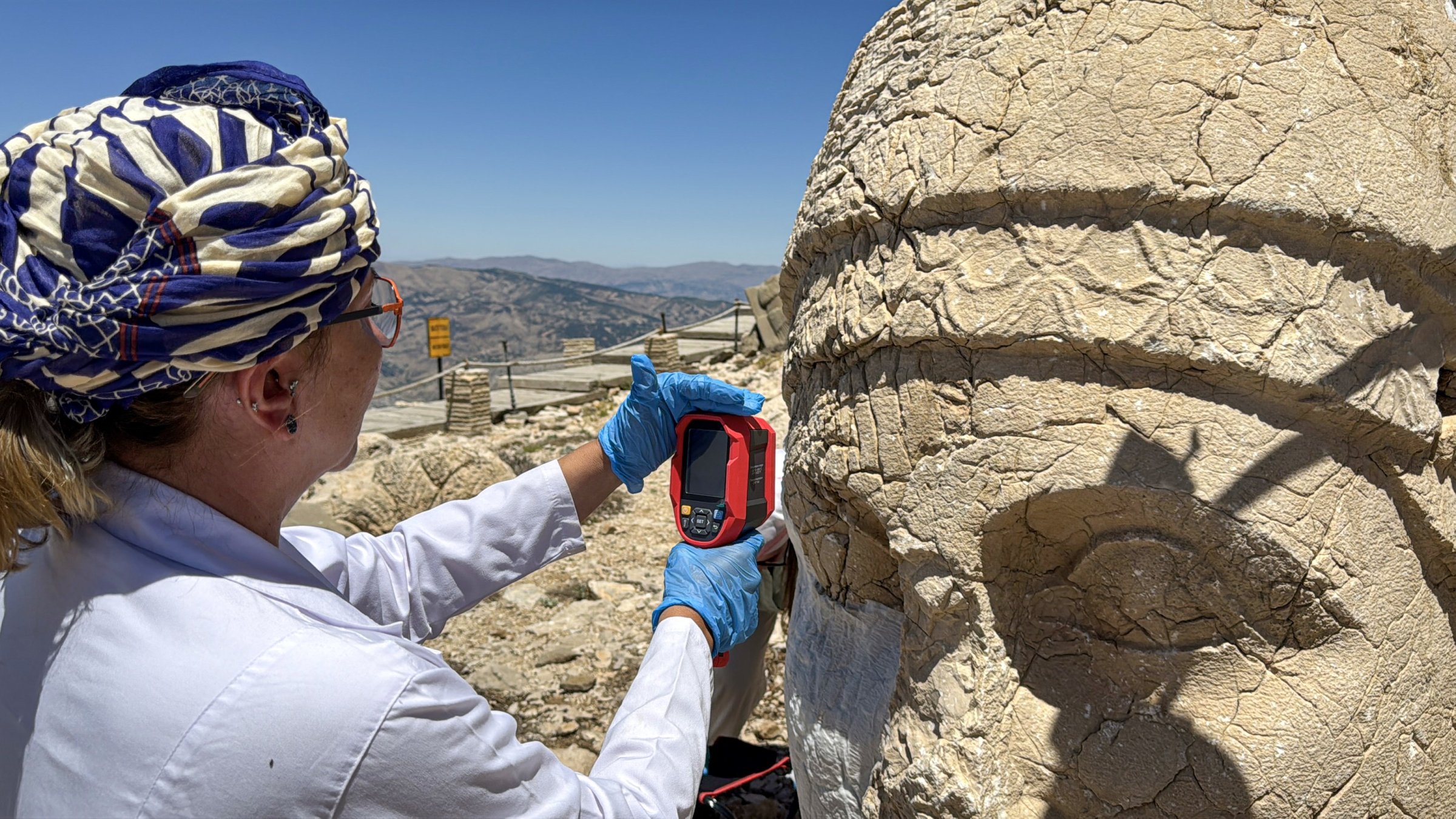 A restoration worker applies a nano-dispersed calcium hydroxide solution to an iconic sculpture at Mount Nemrut, southeastern Türkiye, July 15, 2025. (AA Photo)