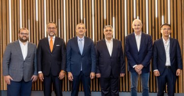 Trendyol Group President Çağlayan Çetin (2nd L), Trendyol Group CEO Erdem Inan (L), Baykar CEO Haluk Bayraktar (3rd L), Alibaba Group President Michael Evans (2nd R), ADQ Group Executive Vice President Mansour AlMulla (R) and Ant International Chief Financial Officer Yi Zhou are seen amid the signing of a memorandum for establishing a fintech platform in Türkiye, July 16, 2025. (AA Photo)