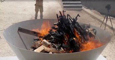 Weapons placed by PKK fighters are burned during a disarming ceremony, Sulaimaniya, Iraq, July 11, 2025. (Reuters Photo)