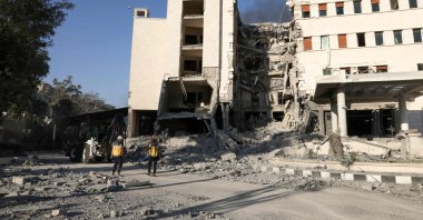 Rescuers walk inside the heavily damaged Syrian army and Defense Ministry headquarters complex, following Israeli strikes, Damascus, Syria, July 16, 2025. (AFP Photo)