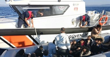 A Turkish coast guard vessel picks up a boat carrying 16  irregular migrants off the coast of the Ayvalik district, western Balikesir province, Türkiye, July 14, 2024. (AA Photo)